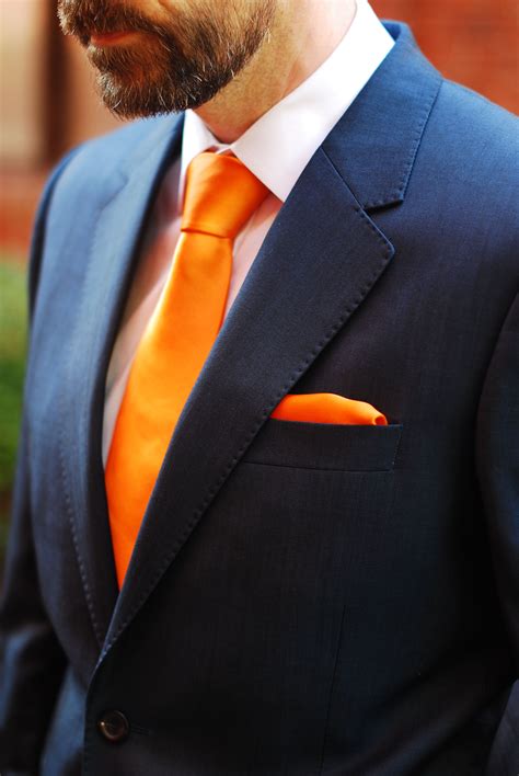 navy blue suit orange tie.